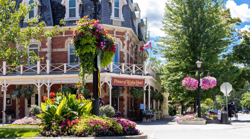 Street corner with a historic red brick building and vibrant flowers